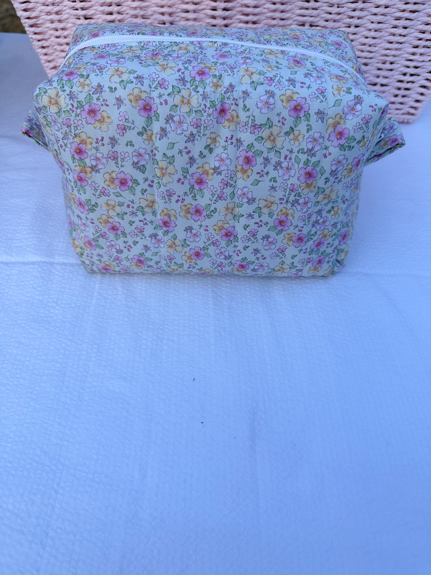 mint color,pink, and yellow floral-patterned quilted boxy pouch with a Mia Grace brand label and a white zipper and pull tabs. Pink Inner Fabric