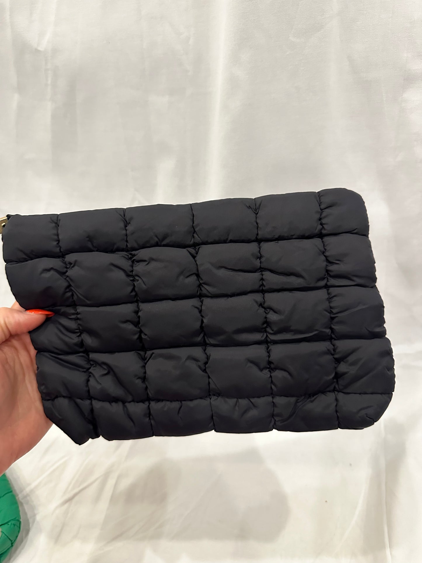 A black quilted puffer cosmetic