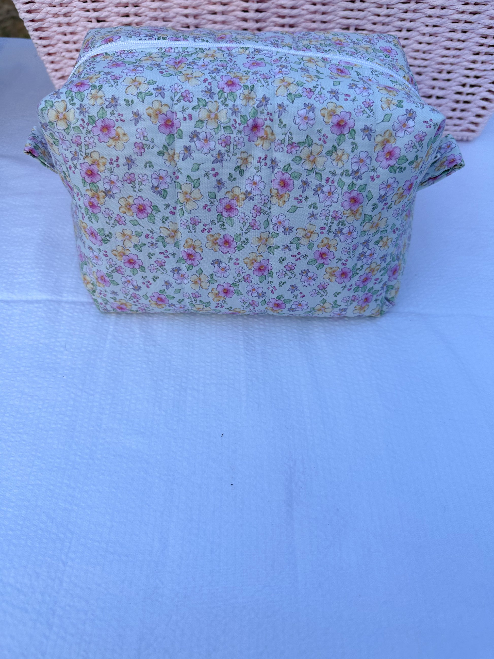 mint color,pink, and yellow  floral-patterned quilted boxy pouch with a Mia Grace brand label and a white zipper and pull tabs. Pink Inner Fabric