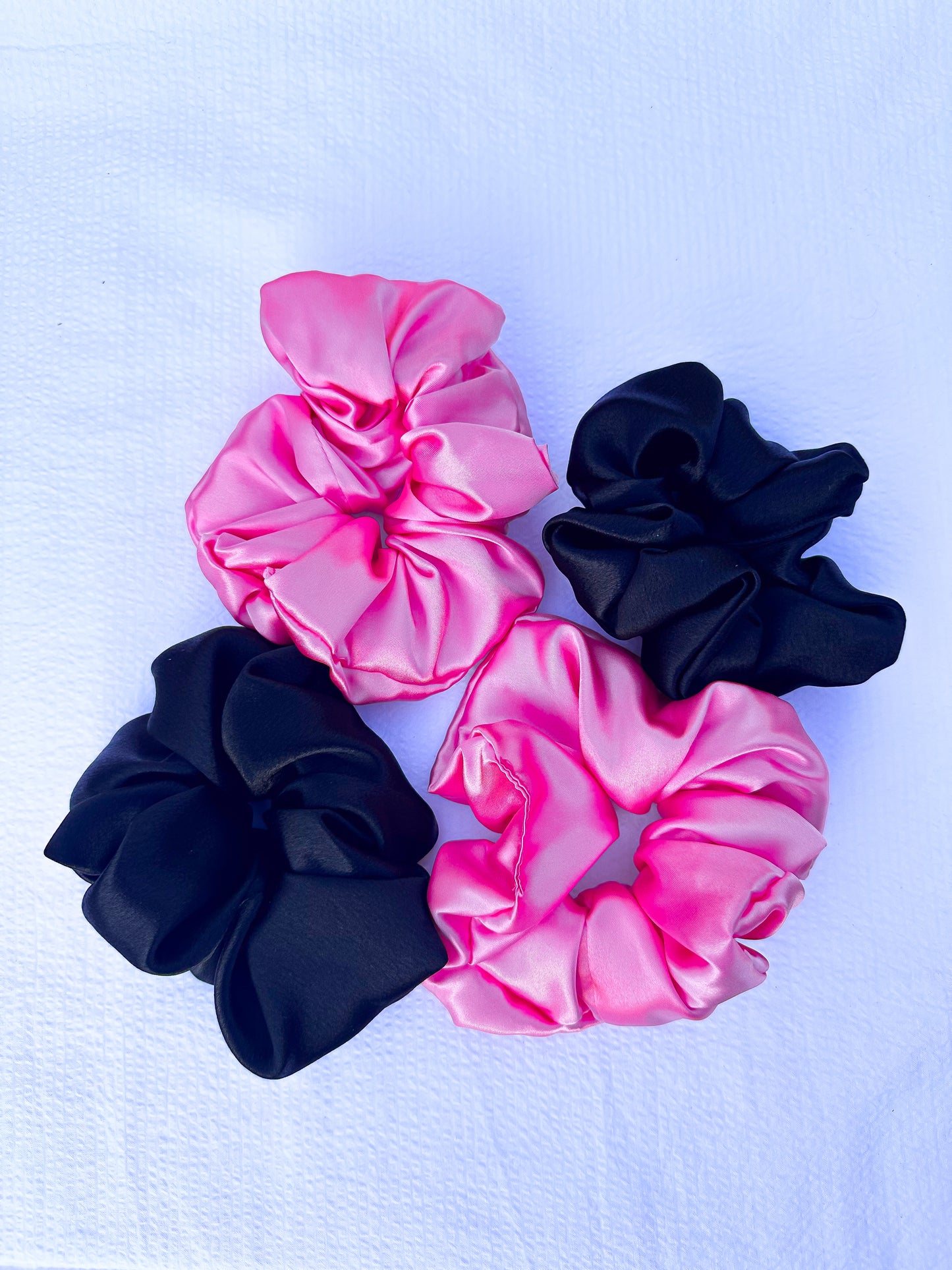 scrunchies in pink and black in an XL size