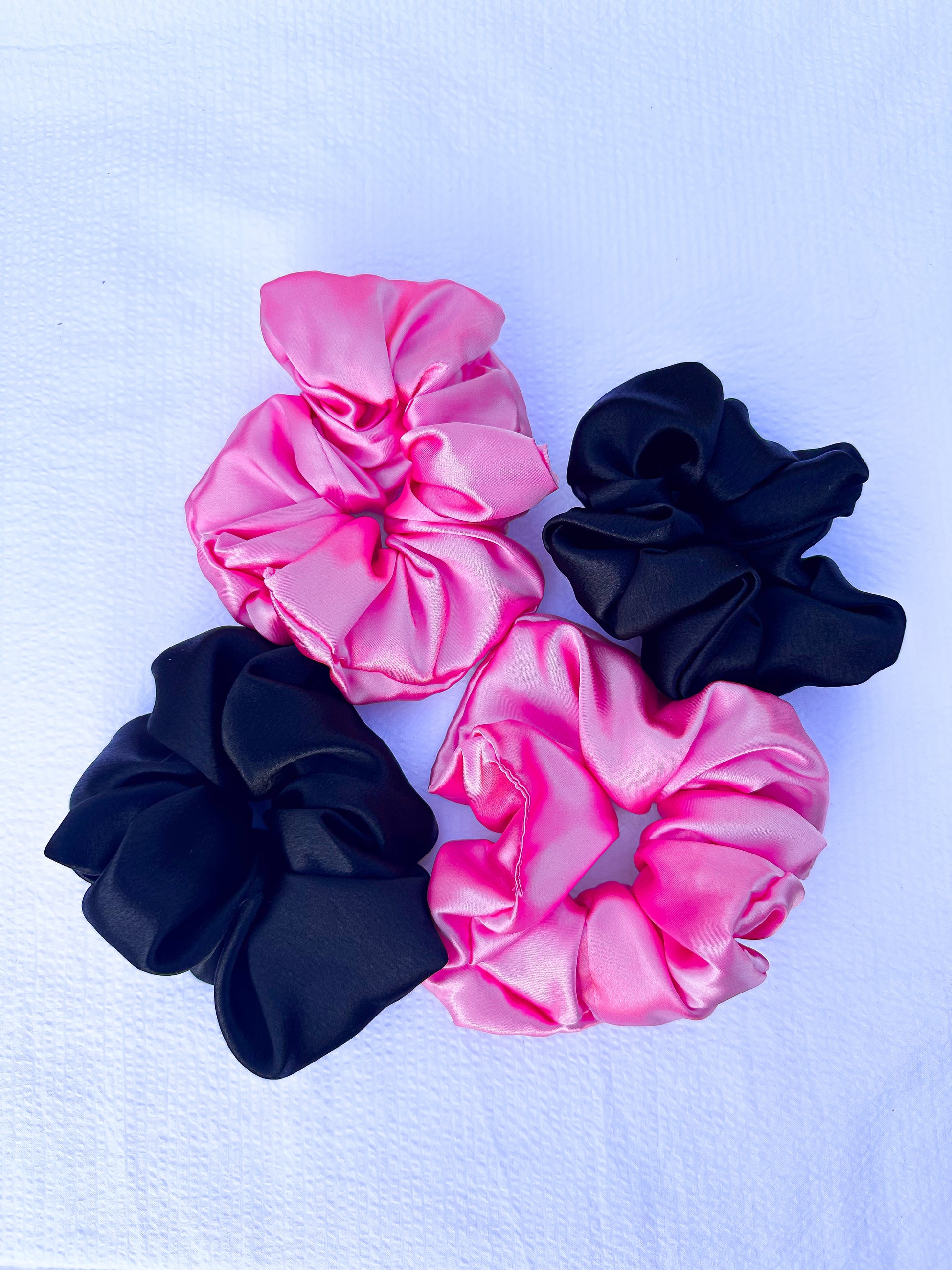 scrunchies in pink and black in an XL size