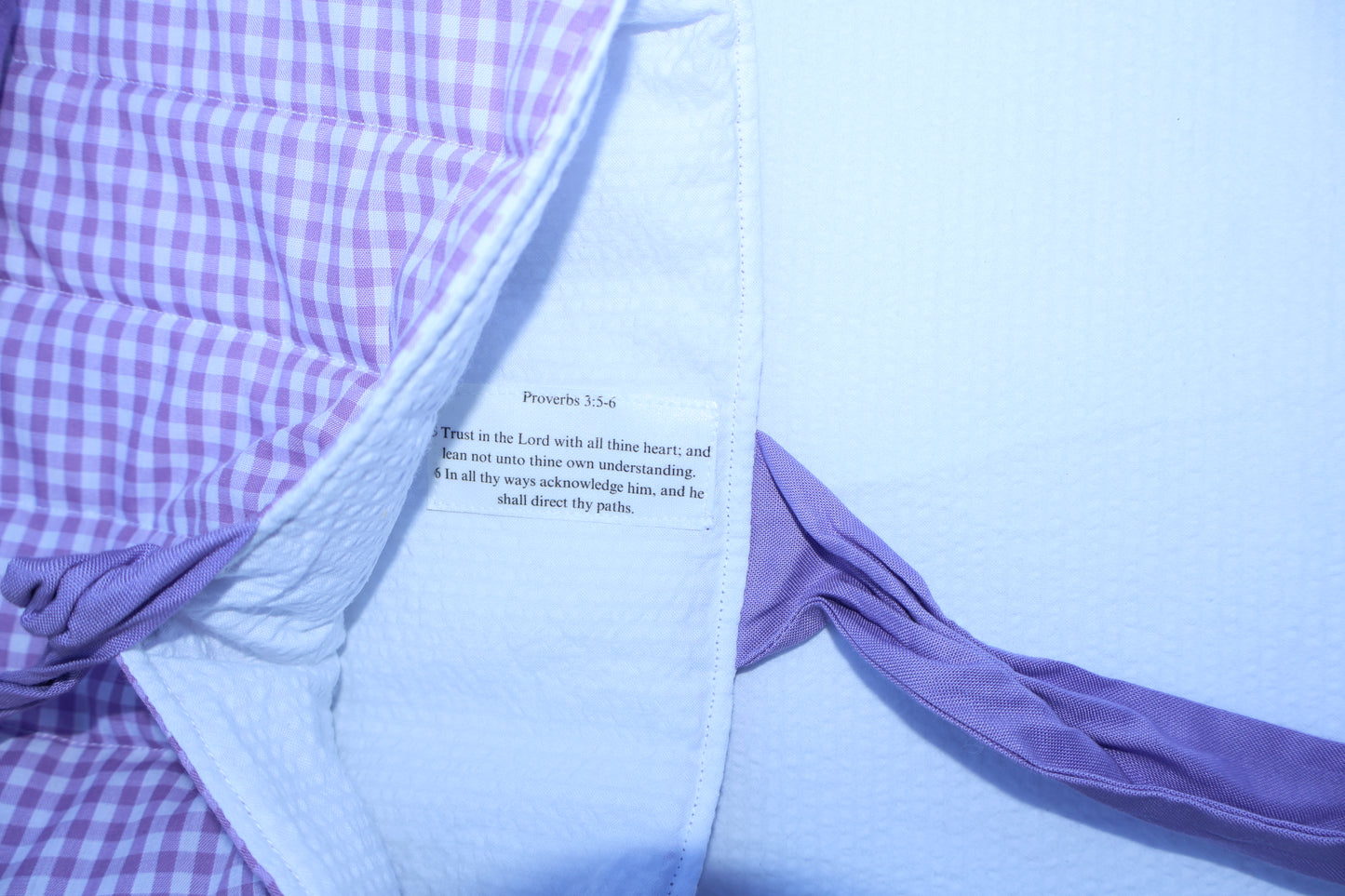 proverbs chapter 3 verse 5 and 6 on a label stitched into the inner  fabric of the bible sleeve. Inner fabric is white and the scripture text is black on a white label.