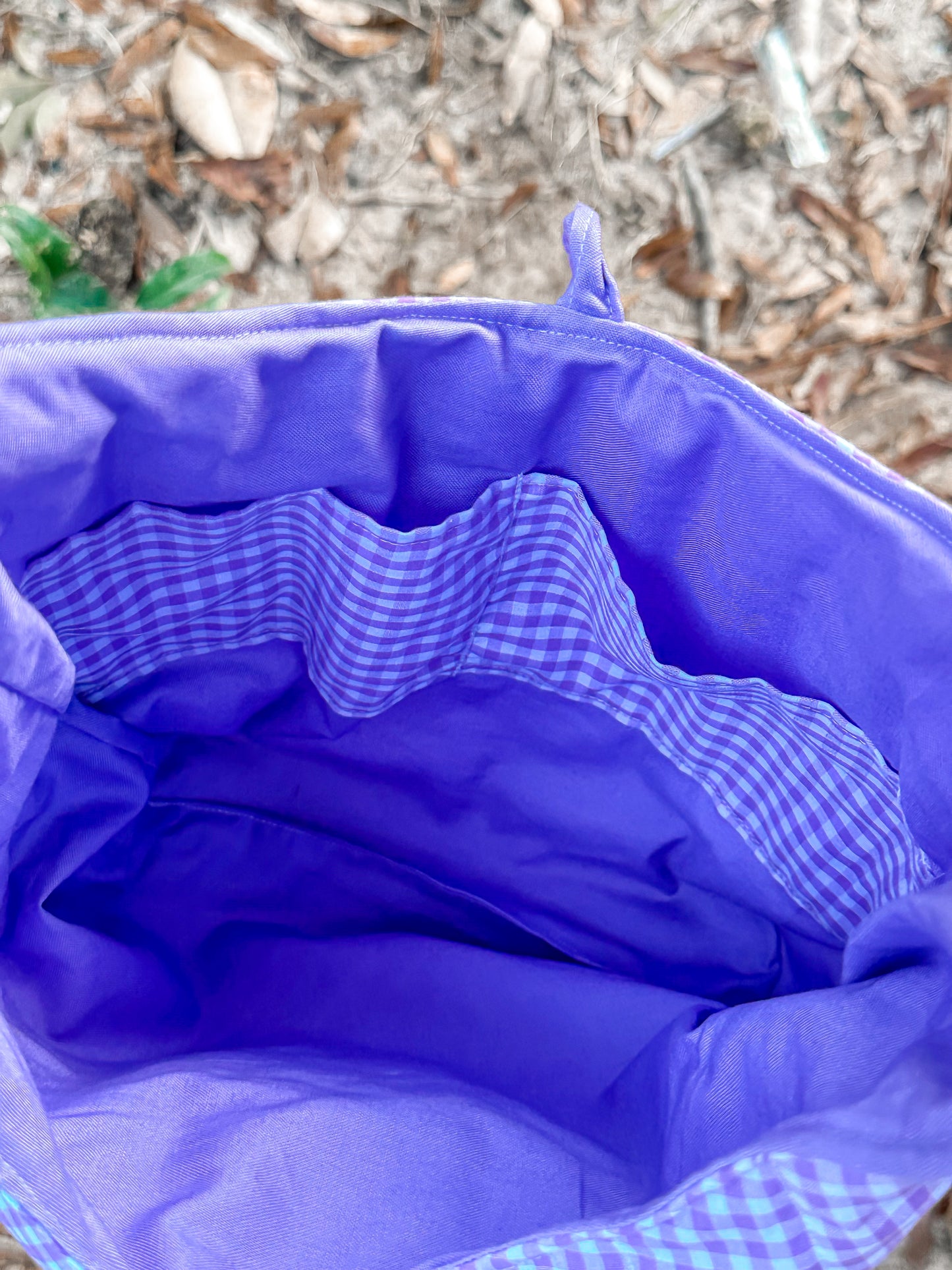close up of the purple inner liner and two gingham print pockets. 