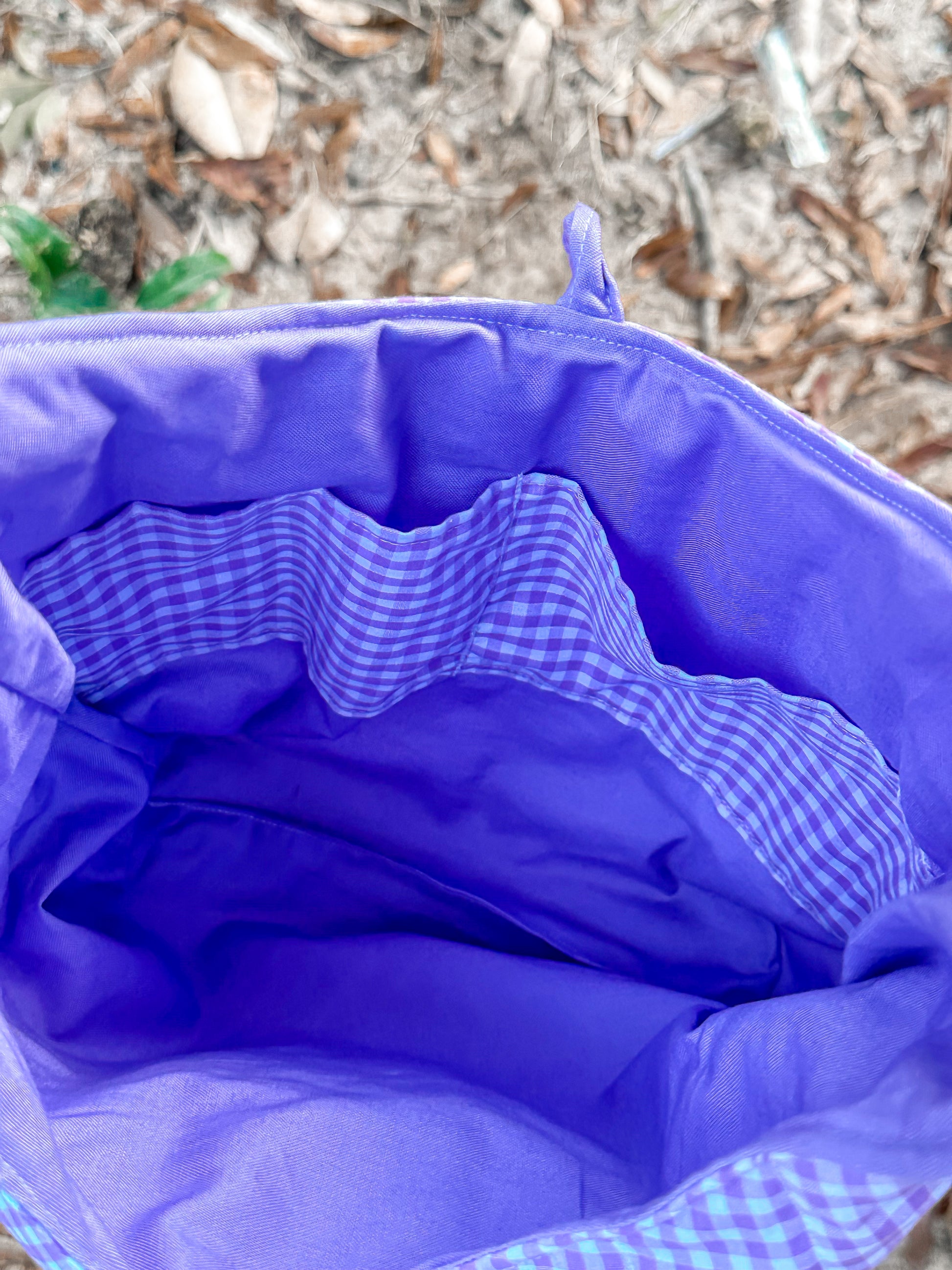 close up of the purple inner liner and two gingham print pockets. 