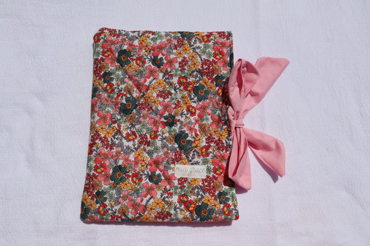 blue, orange, grey, and pink Floral-patterned fabric with a pink bow tie closure and a Mia grace brand label
