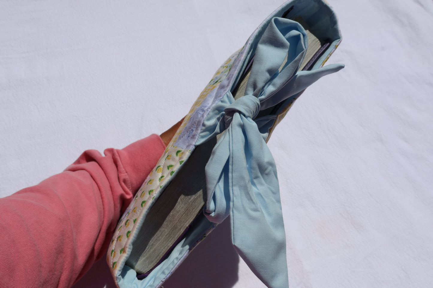 close up of bible inside the bible/book sleeve with the bow tied