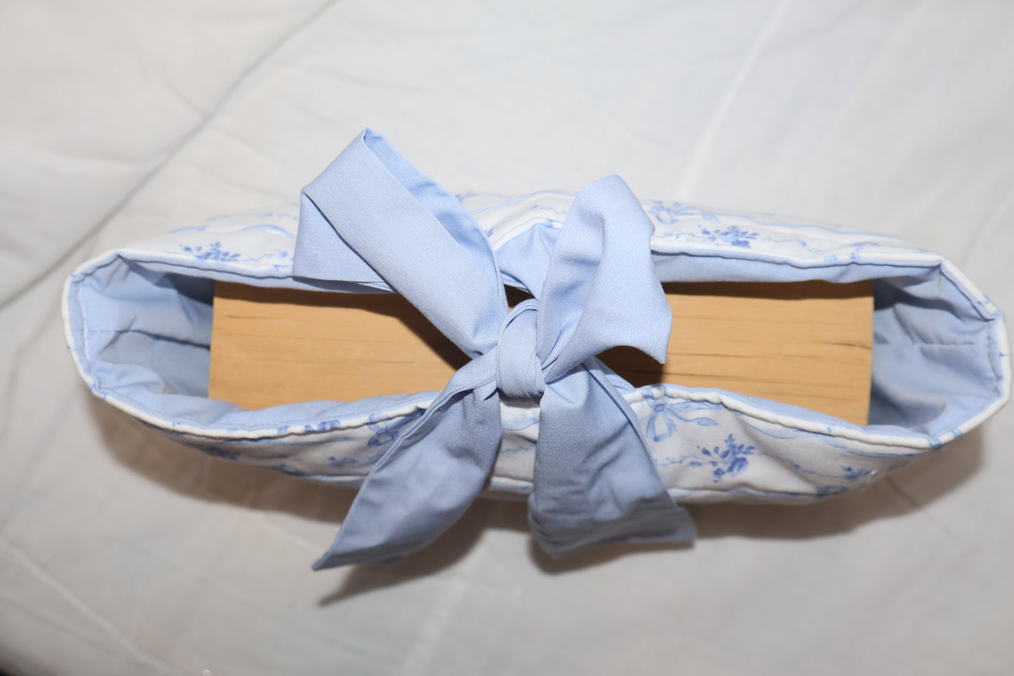 displaying a book inside of the bible/book sleeve with the bow tied 