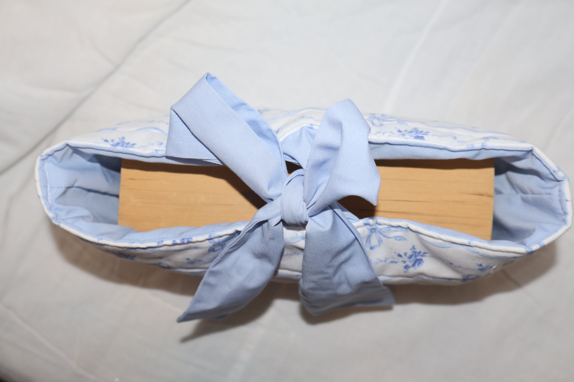 displaying a book inside of the bible/book sleeve with the bow tied 